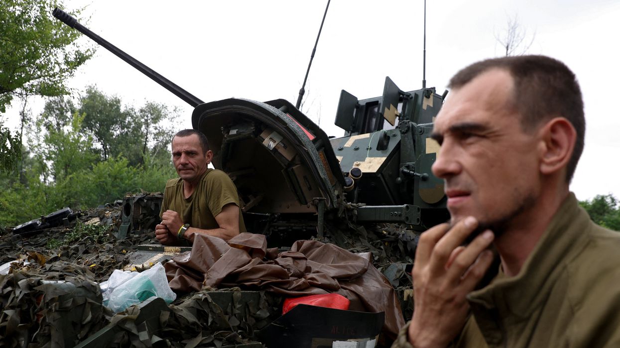 A Ukrainian serviceman of the 47th Magura Separate Mechanized Brigade sits inside a M2 Bradley infantry fighting vehicle