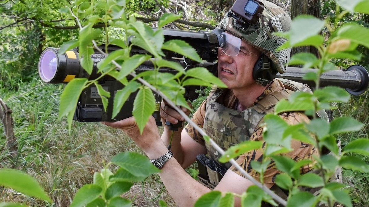 A Ukrainian serviceman searches for a target with a US Stinger air defense missile launcher on the front line in the Zaporizhzhia region.