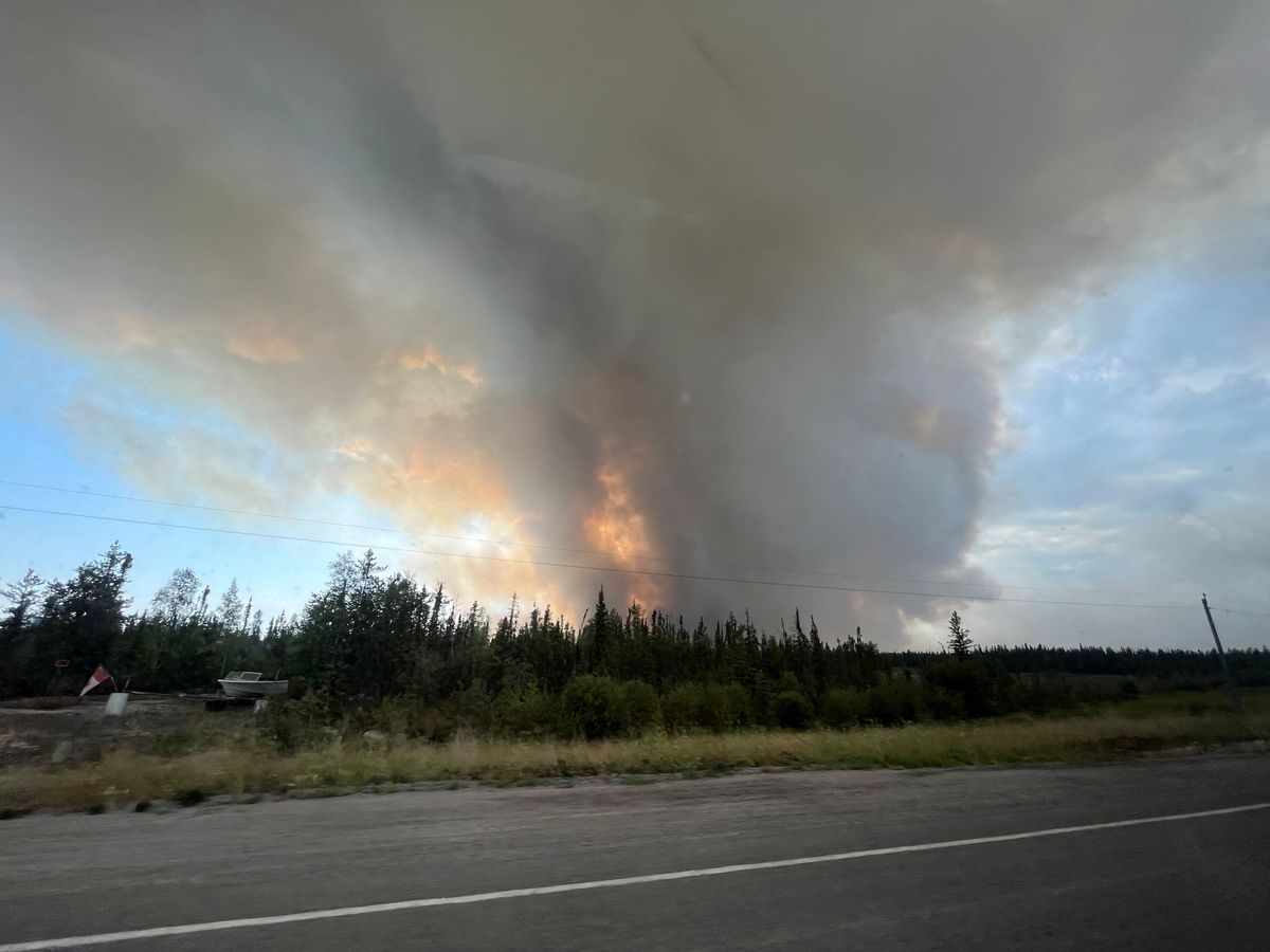 A view shows wildfires near a highway in Yellowknife, Canada.