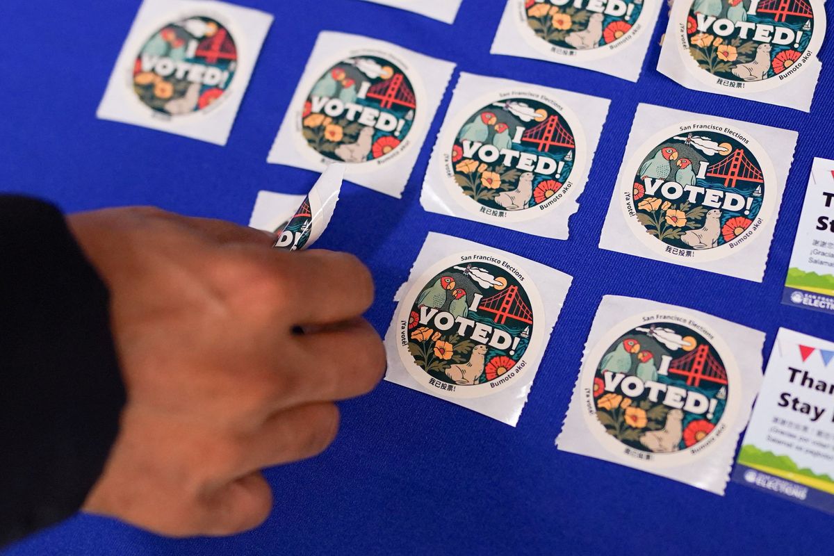 A voter takes a sticker after casting their ballot during early voting, a day ahead of the Super Tuesday primary election, at the San Francisco City Hall voting center in San Francisco, California, U.S. March 4, 2024. 