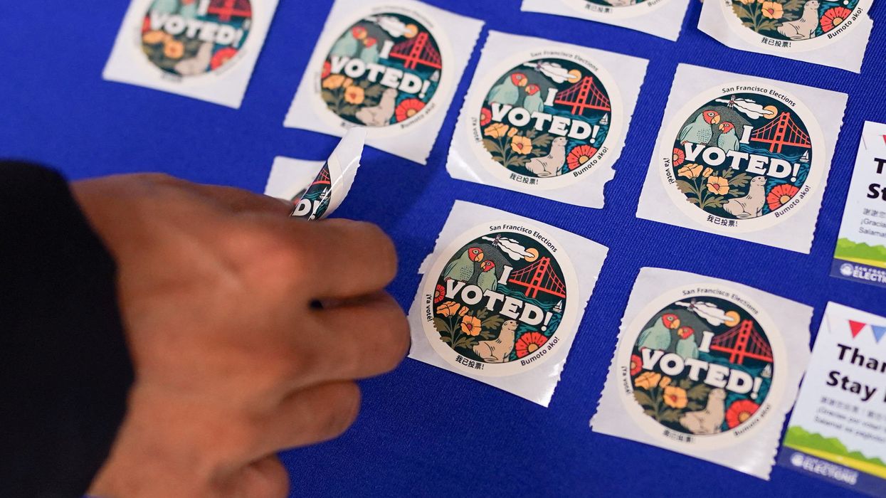 A voter takes a sticker after casting their ballot during early voting, a day ahead of the Super Tuesday primary election, at the San Francisco City Hall voting center in San Francisco, California, U.S. March 4, 2024.