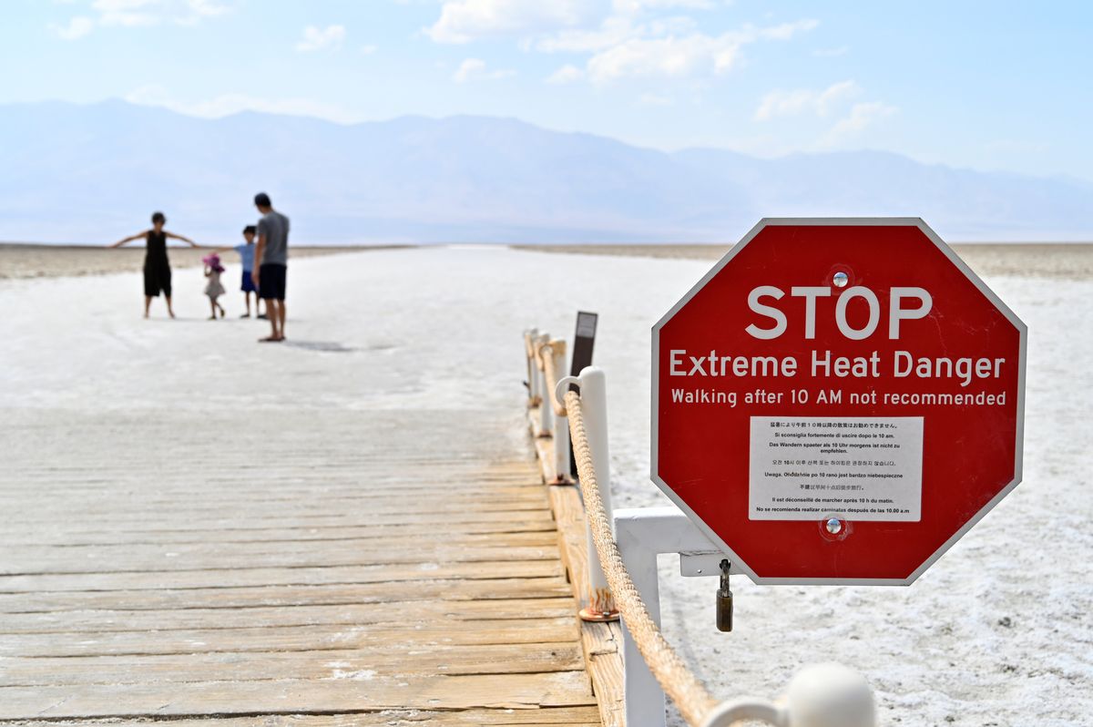 ​A warning sign alerts visitors of the extreme heat dangers at Badwater Basin, the lowest point in North America at 279 feet below sea level, in Death Valley National Park, California, U.S. August 17, 2020. 