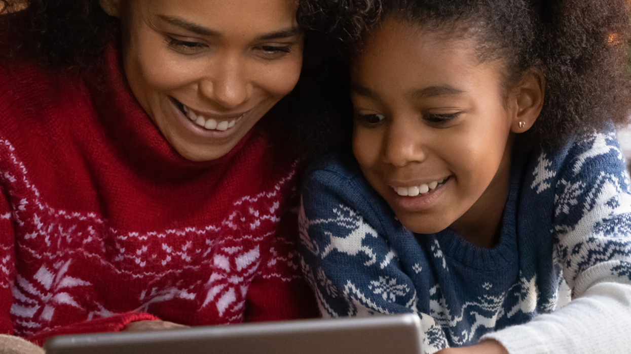 A woman and a pre-teen girl looking at an iPad together