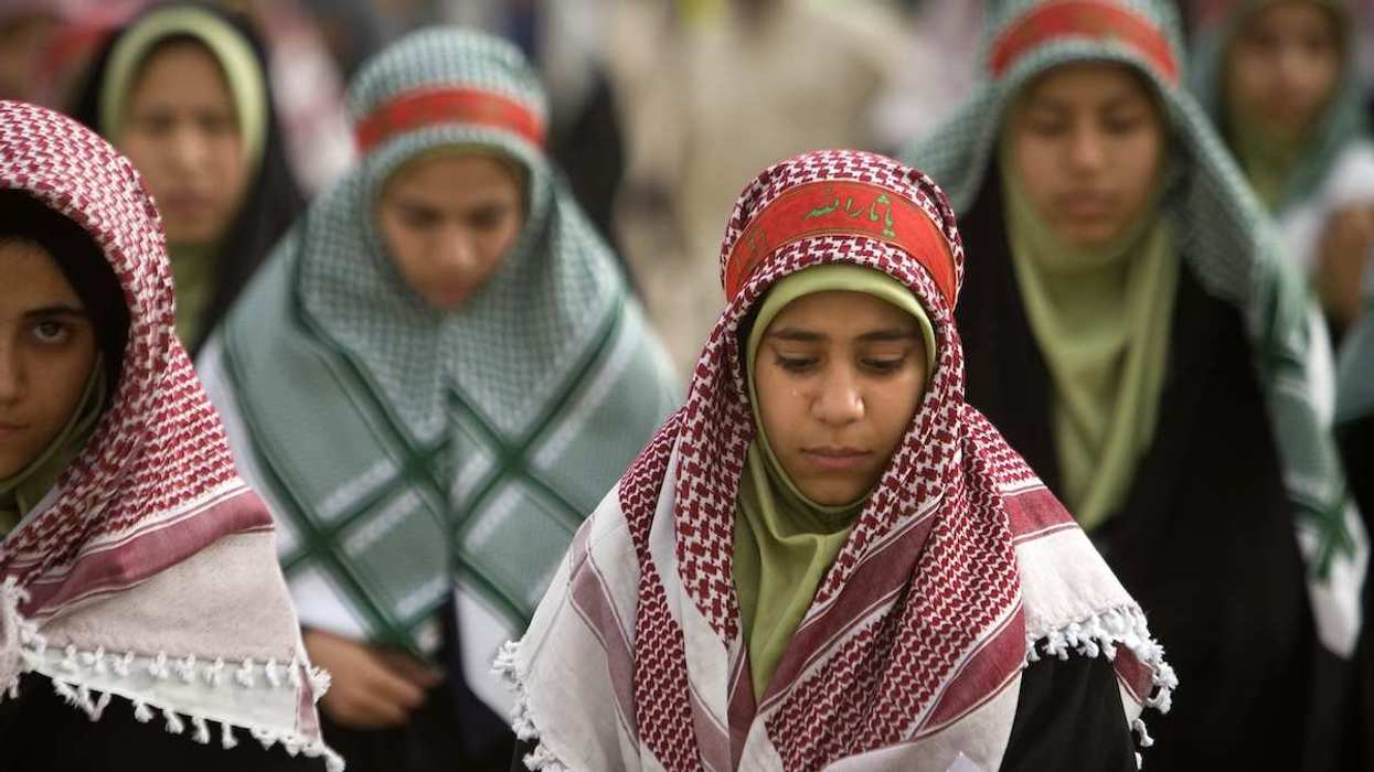 A woman cries as she visits of a war memorial site near the Iraqi border, 1,365 km (854 miles) southwest of Tehran in Khoozestan province, March 16, 2009.