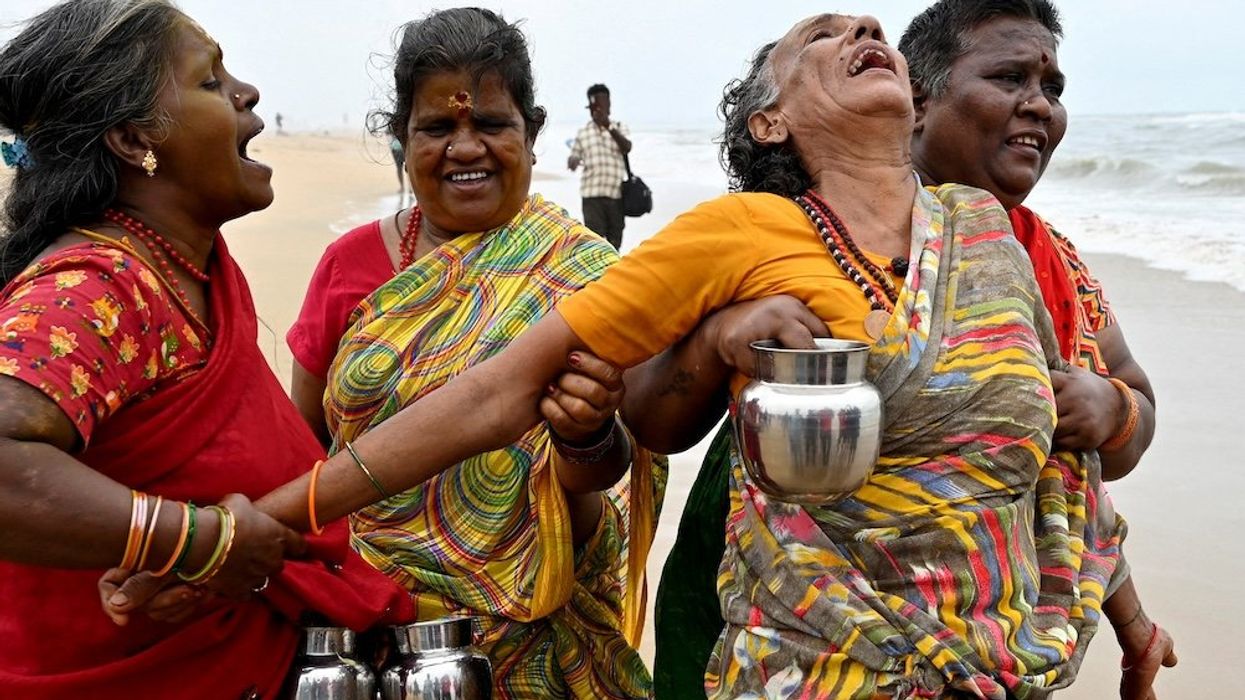 A woman is consoled as she cries during a prayer ceremony for the victims of the 2004 Indian Ocean Tsunami on the 20th anniversary of the disaster, at Pattinapakkam beach in Chennai, India, on Dec. 26, 2024.