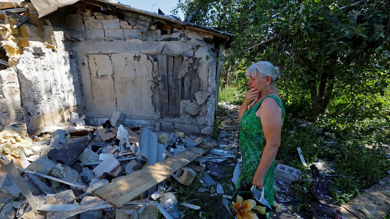 A woman outside the damaged house of her son, who was killed the day before by shelling in Donetsk, Russian-controlled Ukraine.