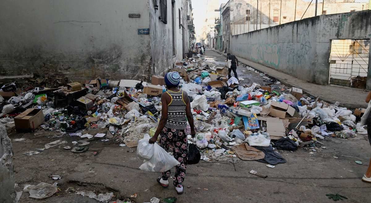 A woman prepares to throw trash on a street in downtown Havana, Cuba, February 16, 2026. ​