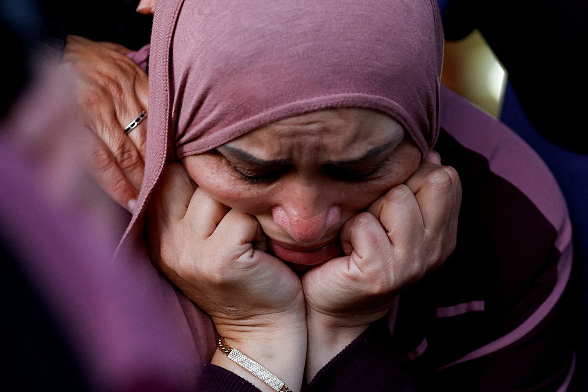 A woman reacts during the funeral of a Palestinian who was killed during clashes following Israeli settlers' attack, near Ramallah.