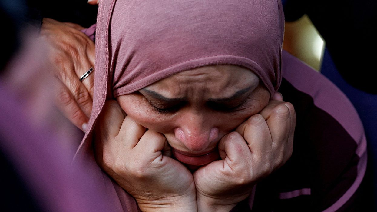 A woman reacts during the funeral of a Palestinian who was killed during clashes following Israeli settlers' attack, near Ramallah.