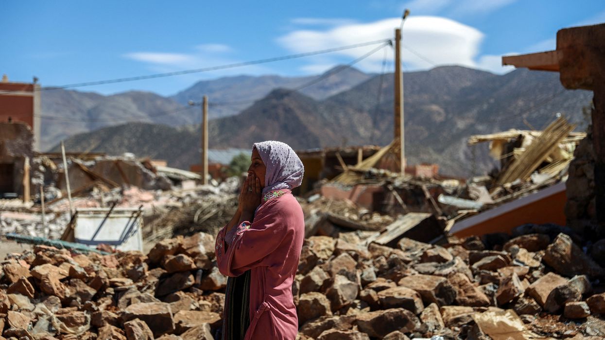 A woman reacts near the rubble of a building in the aftermath of a deadly earthquake in Talat N'yaaqoub, Morocco, September 11, 2023.
