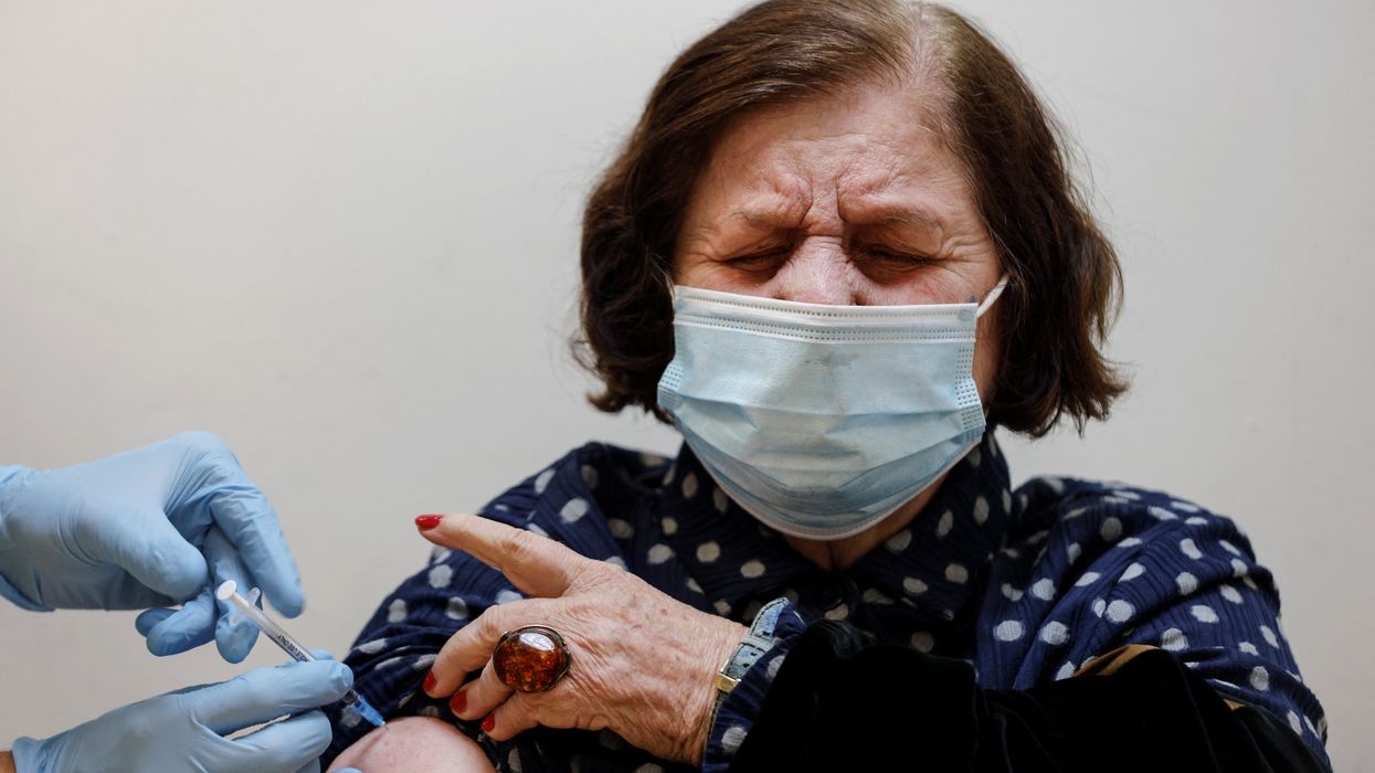 A woman receives the fourth dose of the coronavirus disease (COVID-19) vaccine after Israel approved a second booster shot for the immunocompromised, people over 60 years and medical staff, in Tel Aviv, Israel January 3, 2022
