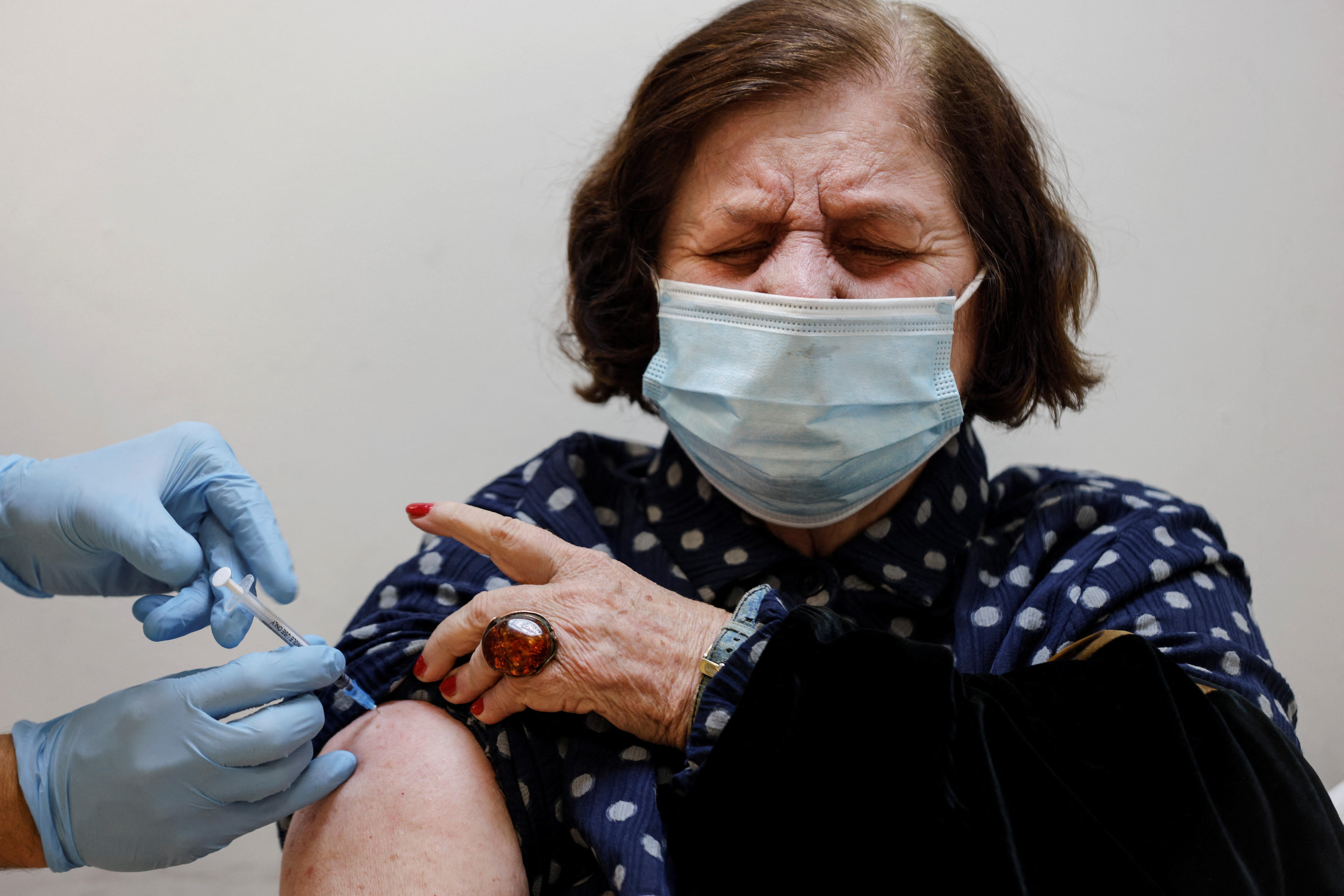 A woman receives the fourth dose of the coronavirus disease (COVID-19) vaccine after Israel approved a second booster shot for the immunocompromised, people over 60 years and medical staff, in Tel Aviv, Israel January 3, 2022