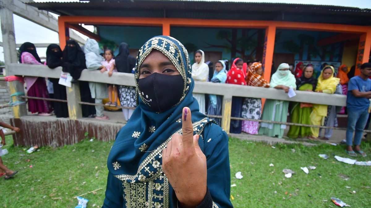 ​A woman shows her ink-marked finger after casting her ballot at a polling station during the Assam Legislative Assembly election in Nagaon District, Assam, India, on April 9, 2026. 