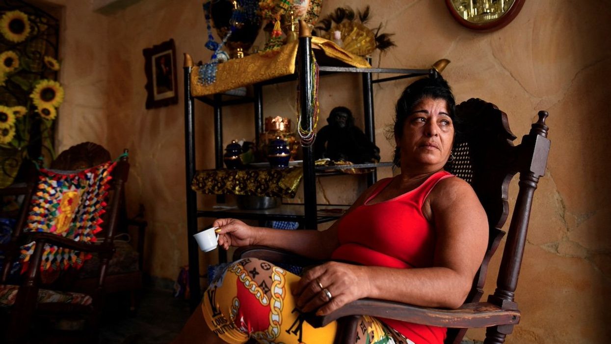 A woman sitting at her house, looks on as Cuba suffers a third major setback in restoring power to the island, with millions still without electrical service, in Havana, Cuba, October 20, 2024.
