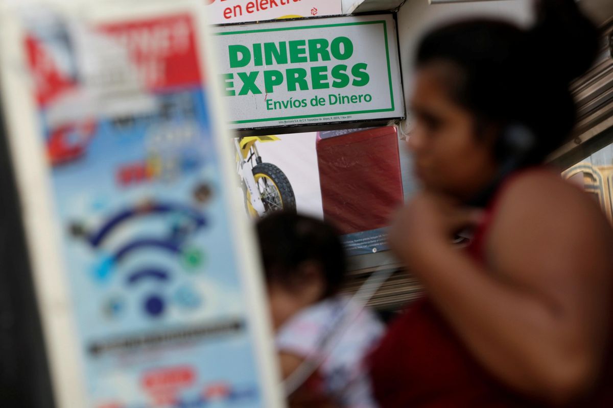 ​A woman speaks on the phone outside a money exchange office in Ciudad Juarez, Mexico. 