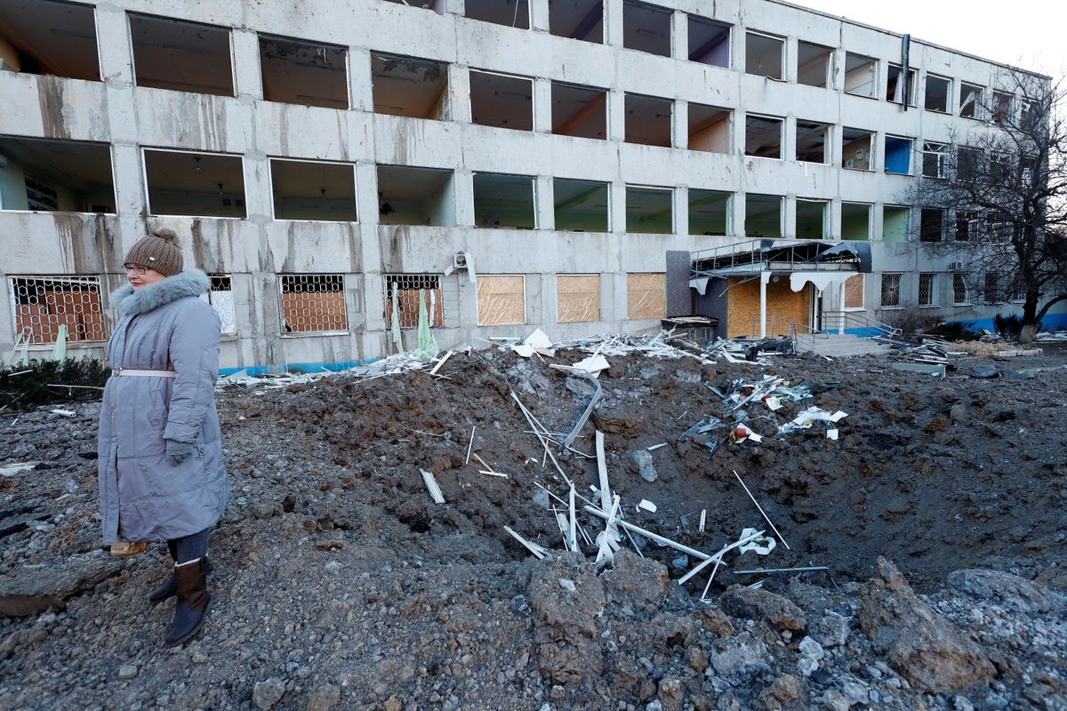 A woman stands at the site of an overnight Russian missile strike that occurred in Kramatorsk, Ukraine.