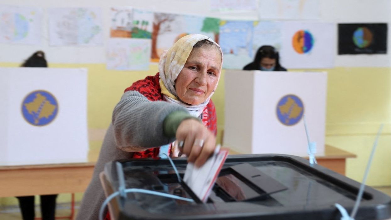 A woman votes during the parliamentary elections, in Pristina, Kosovo, February 9, 2025. R