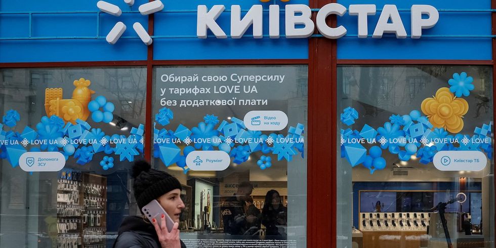 A woman walks past a store of Ukraine's telecommunications company Kyivstar, amid Russia's attack on Ukraine, in Kyiv, Ukraine December 12, 2023.