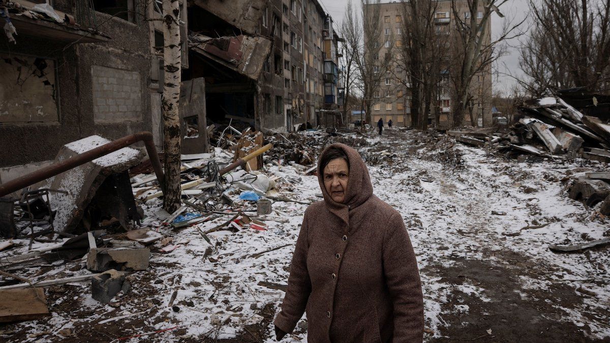 ​A woman walks past apartment blocks that were destroyed in a Russian missile strike, amid Russia’s attack on Ukraine, in Selydove near Avdiivka, Ukraine, February 19, 2024. 