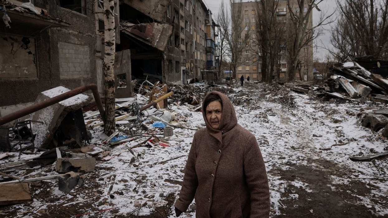 A woman walks past apartment blocks that were destroyed in a Russian missile strike, amid Russia’s attack on Ukraine, in Selydove near Avdiivka, Ukraine, February 19, 2024.