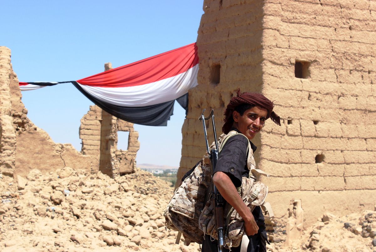 A young Yemeni fighter shouldering a weapon smiles at the camera near Marib, Yemen October 16, 2015. Marib is a city that is heavily armed even by the standards of Yemen, where the ready availability of weapons helped start civil war and is now preventing anyone coming out on top. Yemenis often say there are three guns for every person, a boast that has become an urgent concern in a country where the United Nations says the humanitarian situation is "critical".
