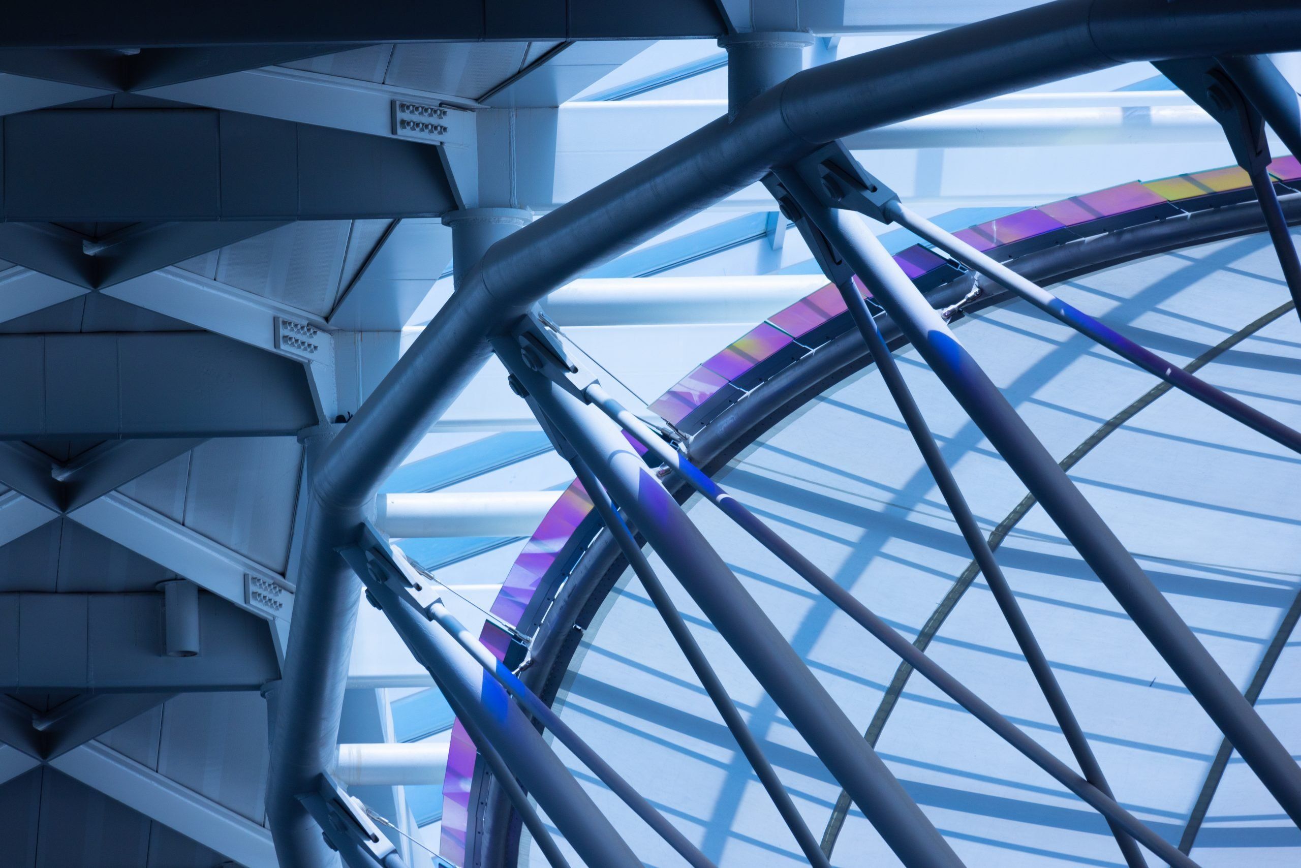 Abstract-style photo of a high-tech building interior ceiling with crisscrossed bars