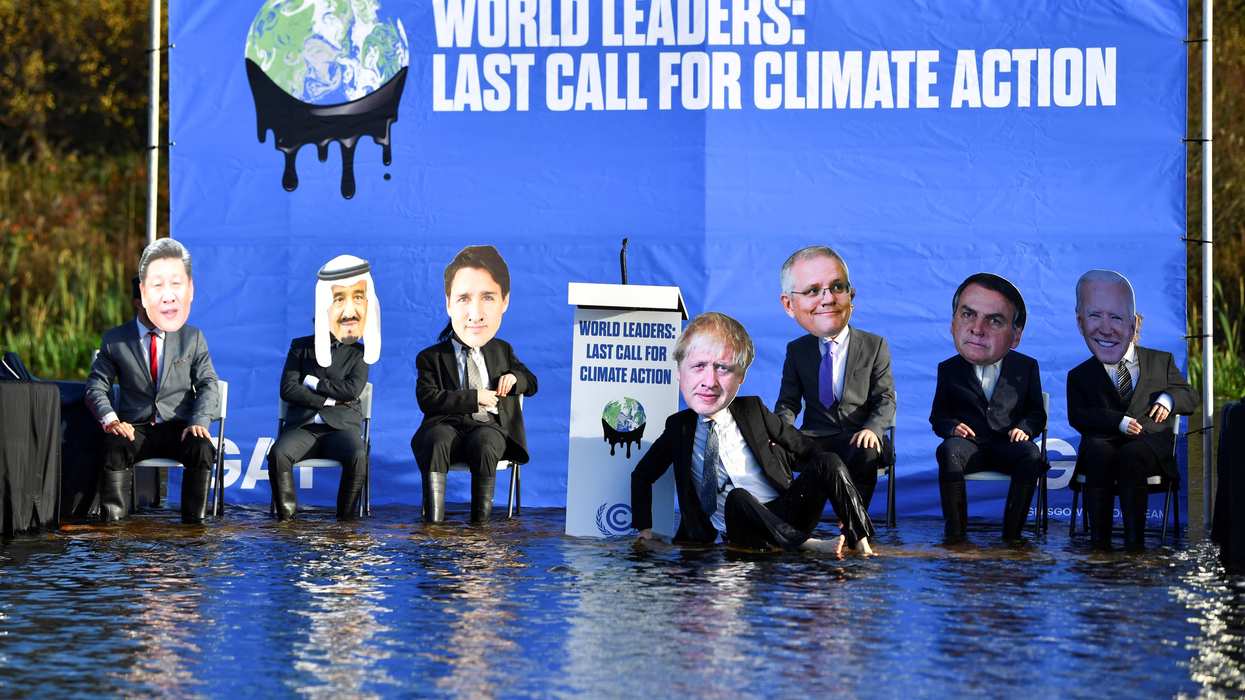 Activists dressed as world leaders protest against the rising water levels during a demonstration on the Forth and Clyde Canal as the UN Climate Change Conference (COP26) takes place, in Glasgow, Scotland, Britain, November 9, 2021.