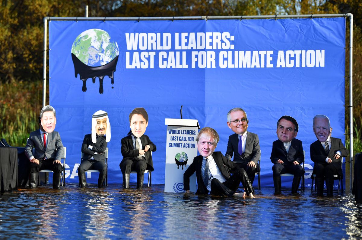 Activists dressed as world leaders protest against the rising water levels during a demonstration on the Forth and Clyde Canal as the UN Climate Change Conference (COP26) takes place, in Glasgow, Scotland, Britain, November 9, 2021. 
