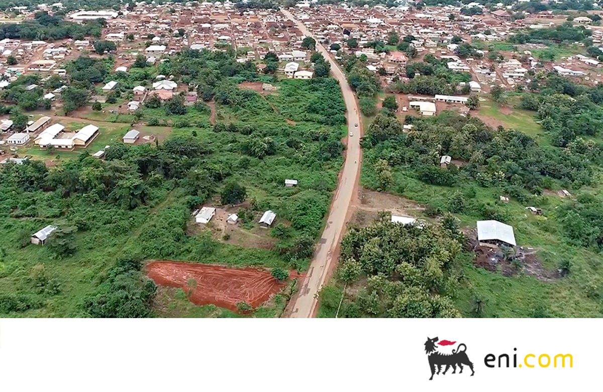 Aerial view of a rural area with trees and a winding road in Ghana.