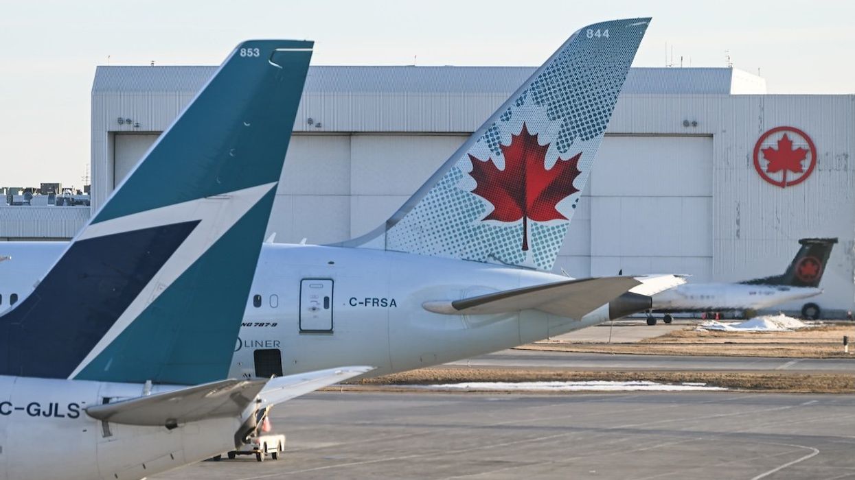 Air Canada and Westjet aircraft parked at Calgary International Airport, in Calgary, Alberta, Canada.