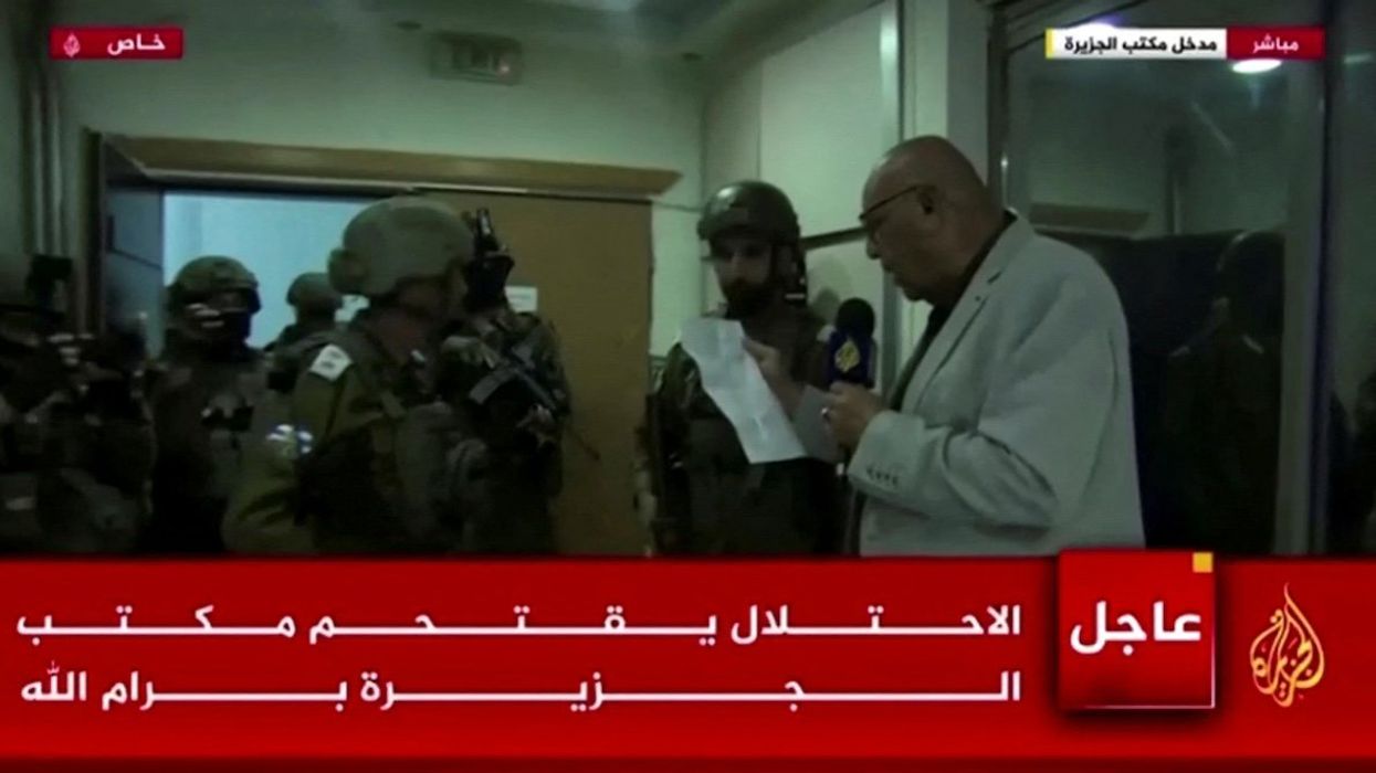 Al Jazeera's bureau chief in Israel and the Palestinian Territories, Walid al-Omari, reads from military order papers that were handed to him by Israeli soldiers at the Al Jazeera office in Ramallah, in the Israeli-occupied West Bank, September 22, 2024 in this screen grab from video.