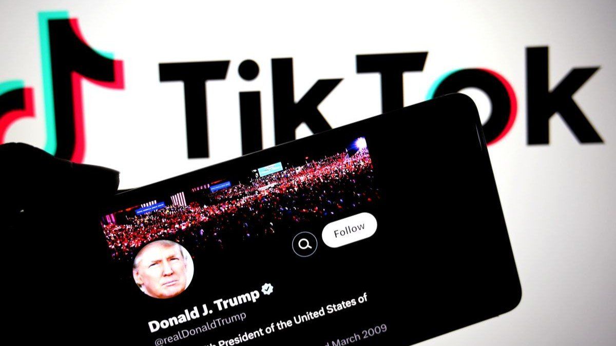 American President Donald Trump's X Page is seen displayed on a smartphone with a Tiktok logo in the background.