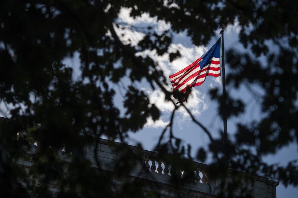 ​An American flag flies atop Russell Senate Office Building on Capitol Hill.