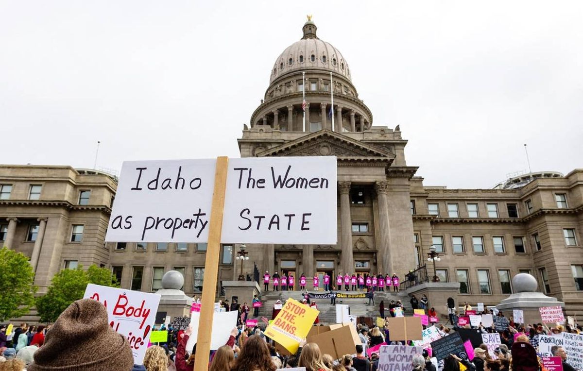 An attendee at an abortion rights rally holds a sign outside the Idaho Capitol on May 14. The U.S. Supreme CourtÂ’s reversal of Roe v. Wade and Planned Parenthood v. Casey, two landmark abortion cases, triggers a law in Idaho that bans most abortions.