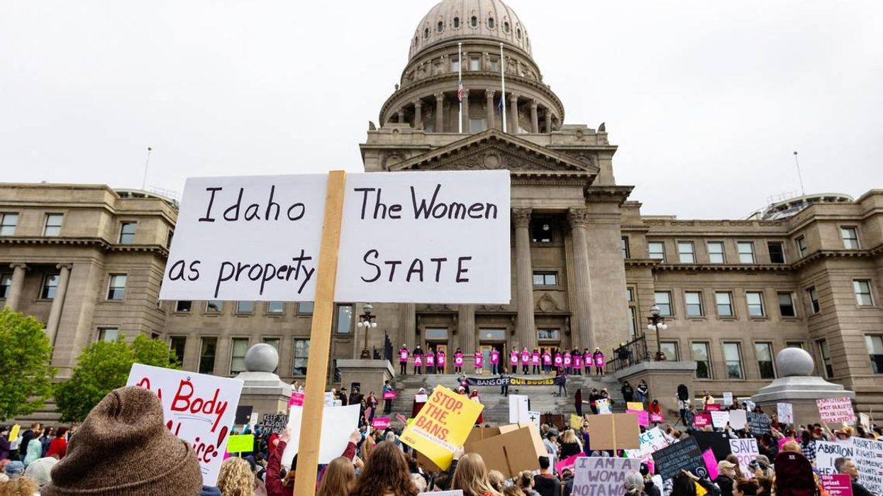 An attendee at an abortion rights rally holds a sign outside the Idaho Capitol on May 14. The U.S. Supreme CourtÂ’s reversal of Roe v. Wade and Planned Parenthood v. Casey, two landmark abortion cases, triggers a law in Idaho that bans most abortions.