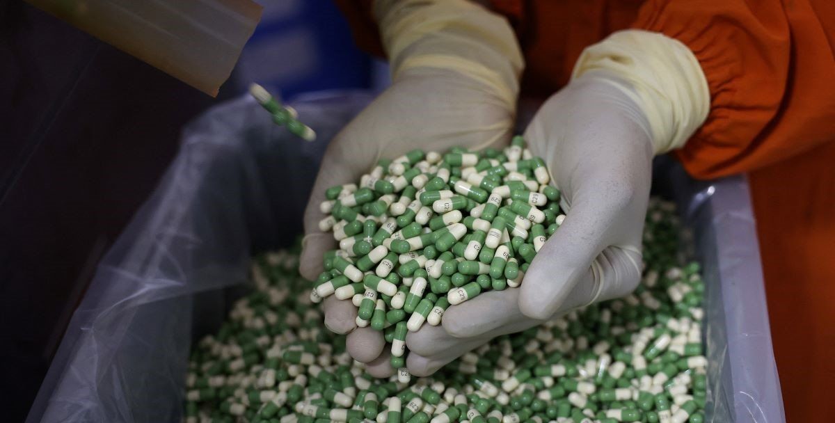 ​An employee checks filled capsules inside a Cadila Pharmaceutical company manufacturing unit at Dholka town on the outskirts of Ahmedabad, India, April 12, 2025. 