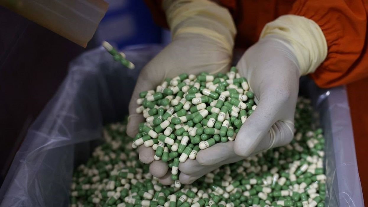 An employee checks filled capsules inside a Cadila Pharmaceutical company manufacturing unit at Dholka town on the outskirts of Ahmedabad, India, April 12, 2025.
