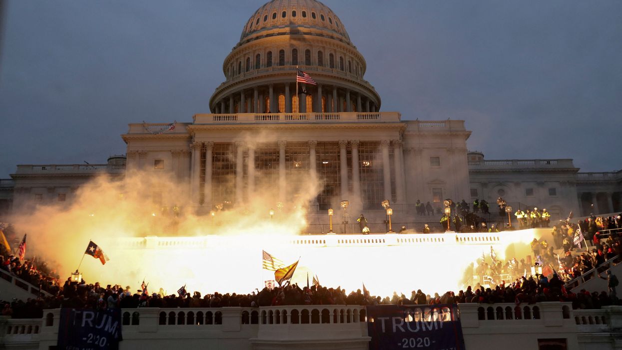 An explosion caused by a police munition while supporters of U.S. President Donald Trump storm the U.S. Capitol Building.