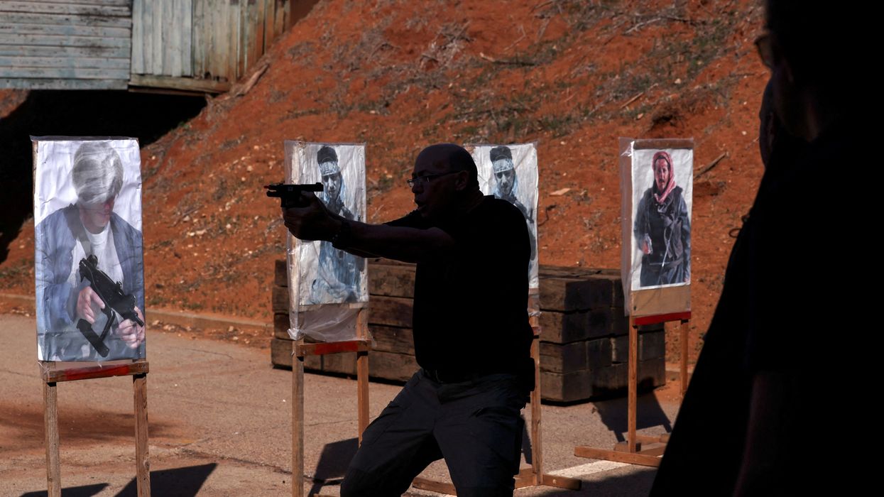 An instructor performs a demonstration during a training session at a shooting range in Kfar Saba, Israel,