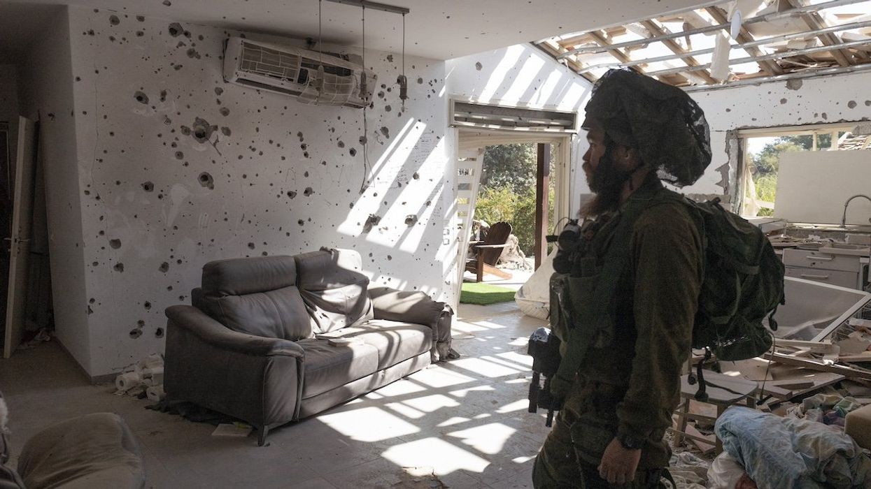 An Israeli infantry soldier inside a Jewish home in Kibbutz Be’eri that was destroyed by Hamas in their October 7, 2023 infiltration of southern Israeli communities. This community was attacked by Hamas infiltrators who killed some 100 people out of 1000 who lived in this community on October 7, 2023.