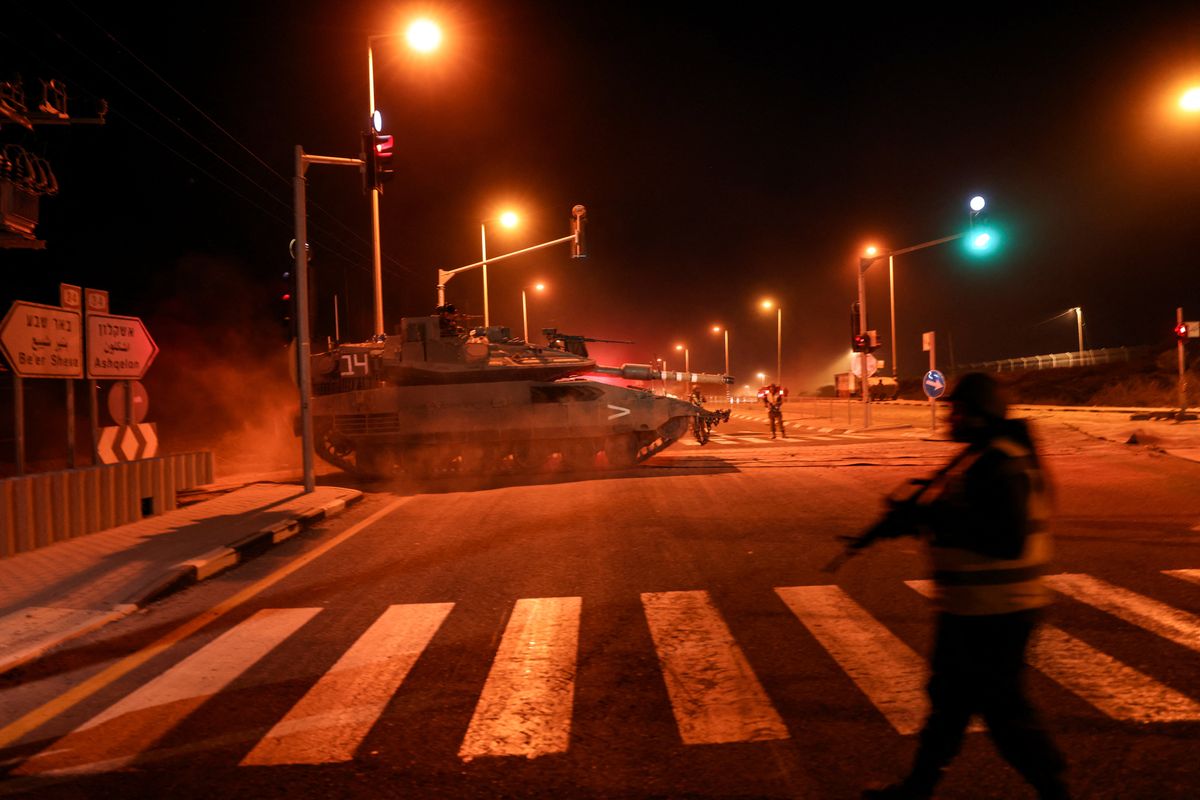 An Israeli soldier maneuvers a tank on a road near Israel's border with the Gaza Strip