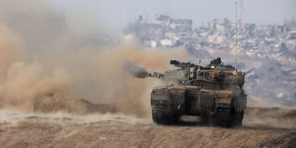 An Israeli tank fires towards Gaza, amid the ongoing conflict between Israel and the Palestinian Islamist group Hamas, at the Israel-Gaza border, in southern Israel, December 27, 2023. 