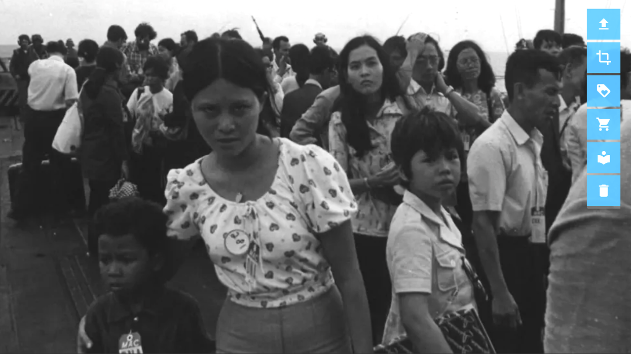 April 29, 1975: Vietnamese refugees line up on the deck of USS Hancock for processing following evacuation from Saigon.