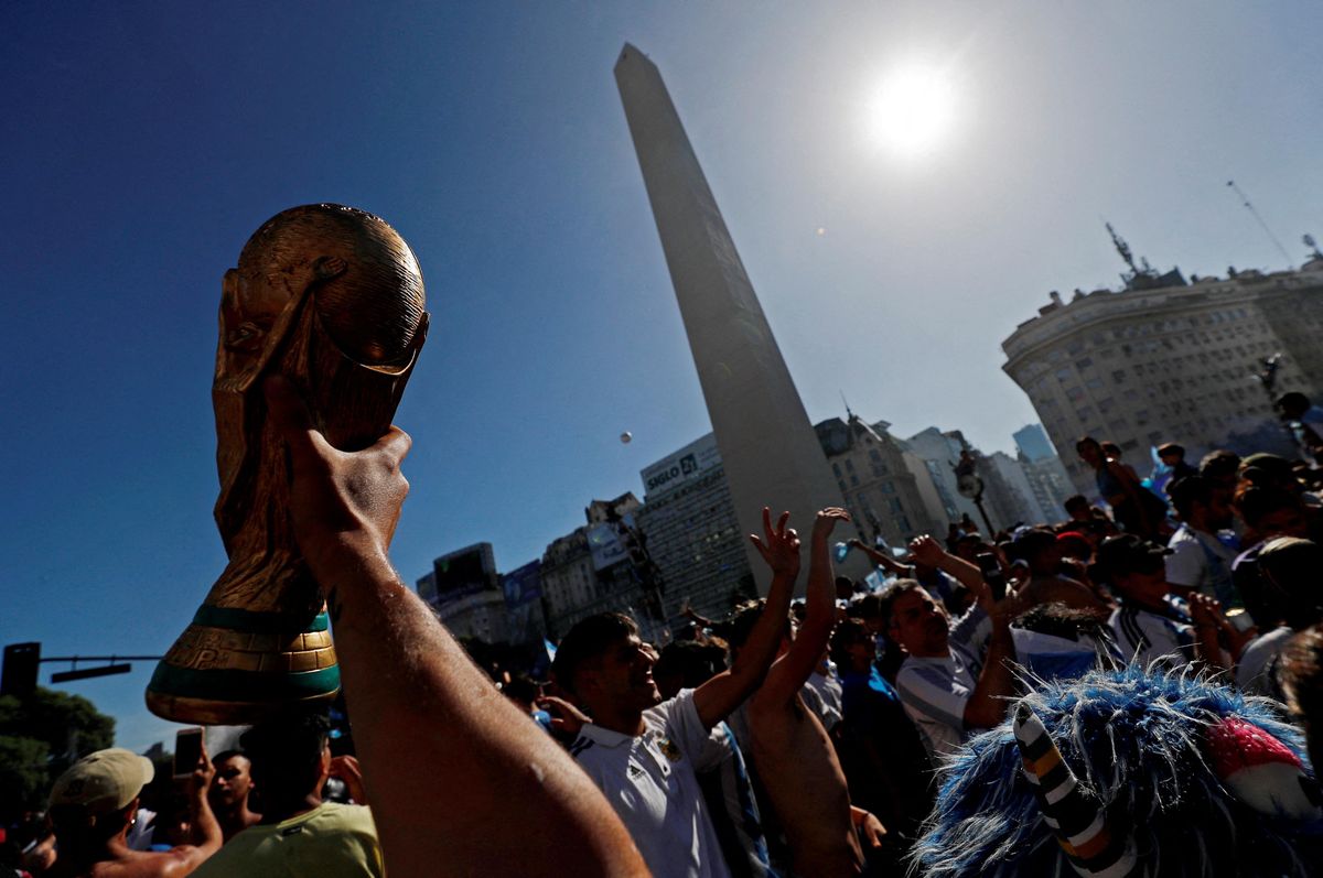 Argentina fans hold a replica trophy as they celebrate winning the World Cup in Buenos Aires.