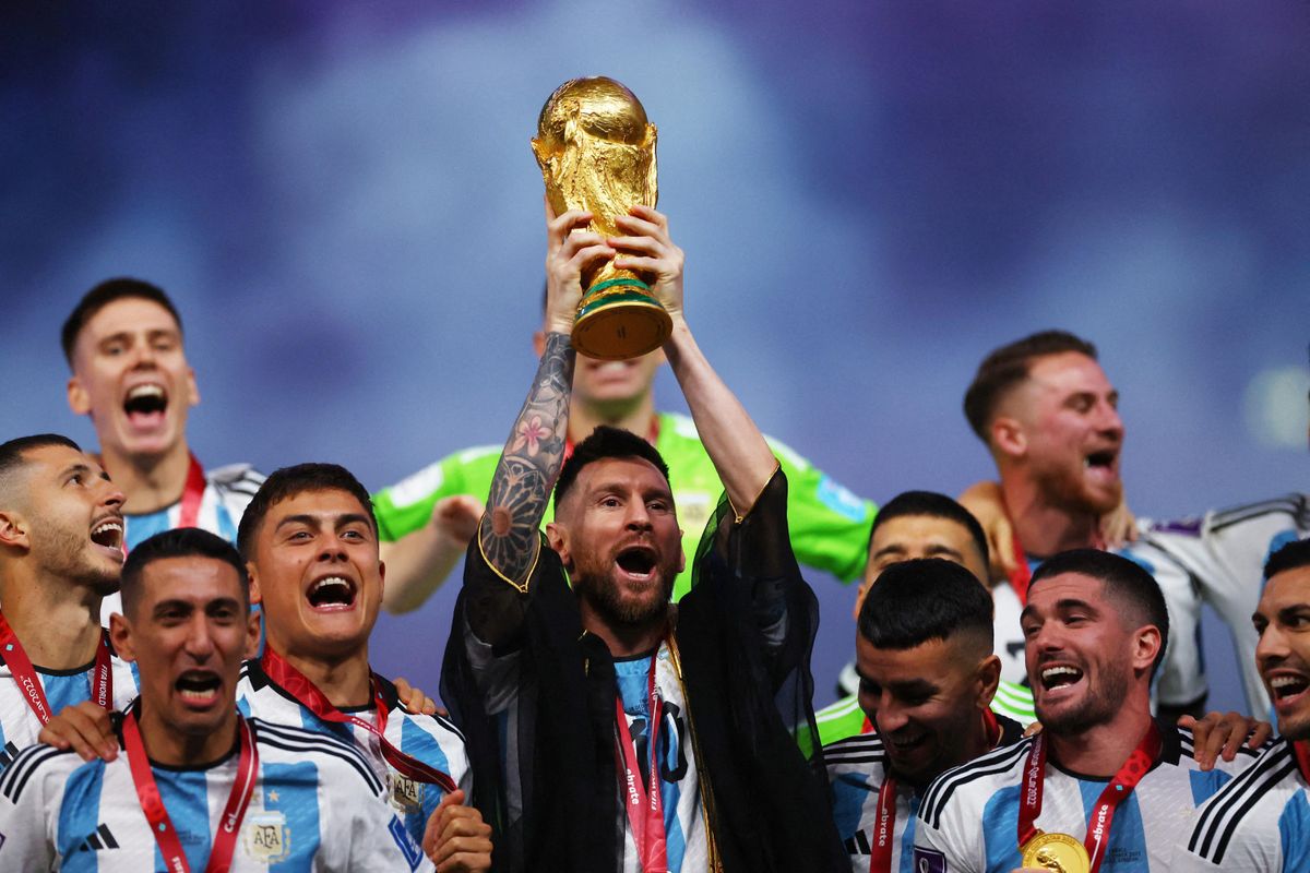 Argentina's Leo Messi lifts the World Cup trophy alongside teammates in Qatar. 