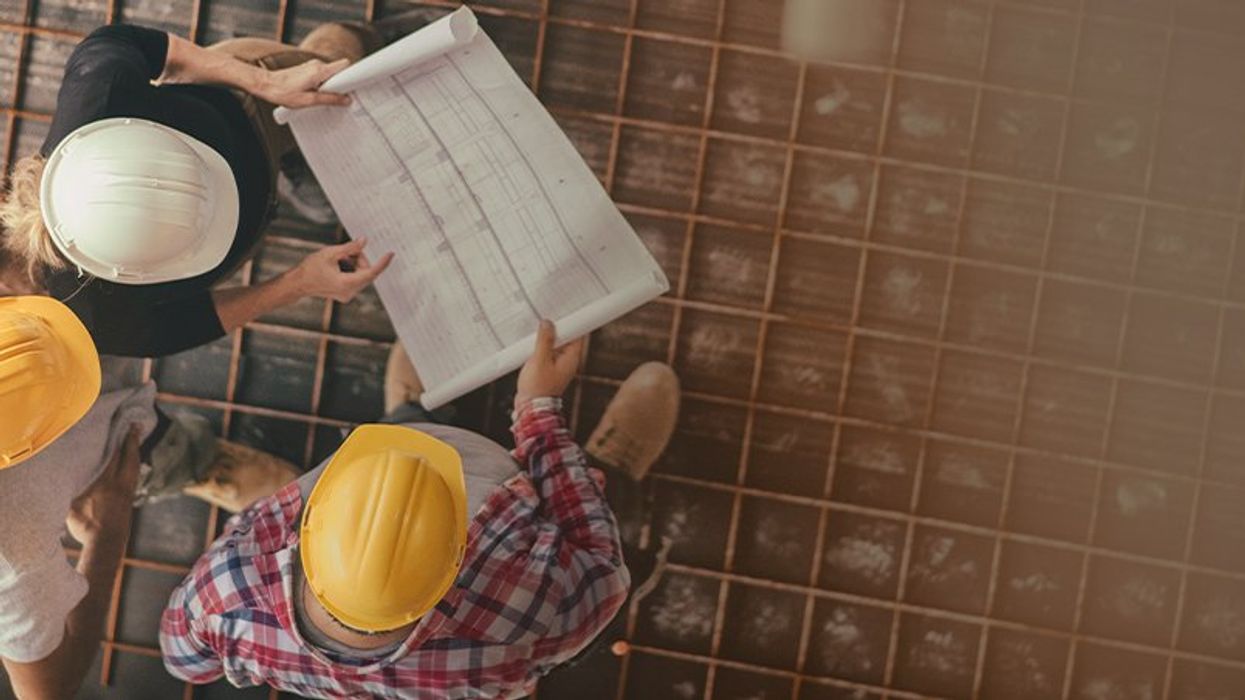 Ariel shot of three engineers looking at an electricity chart
