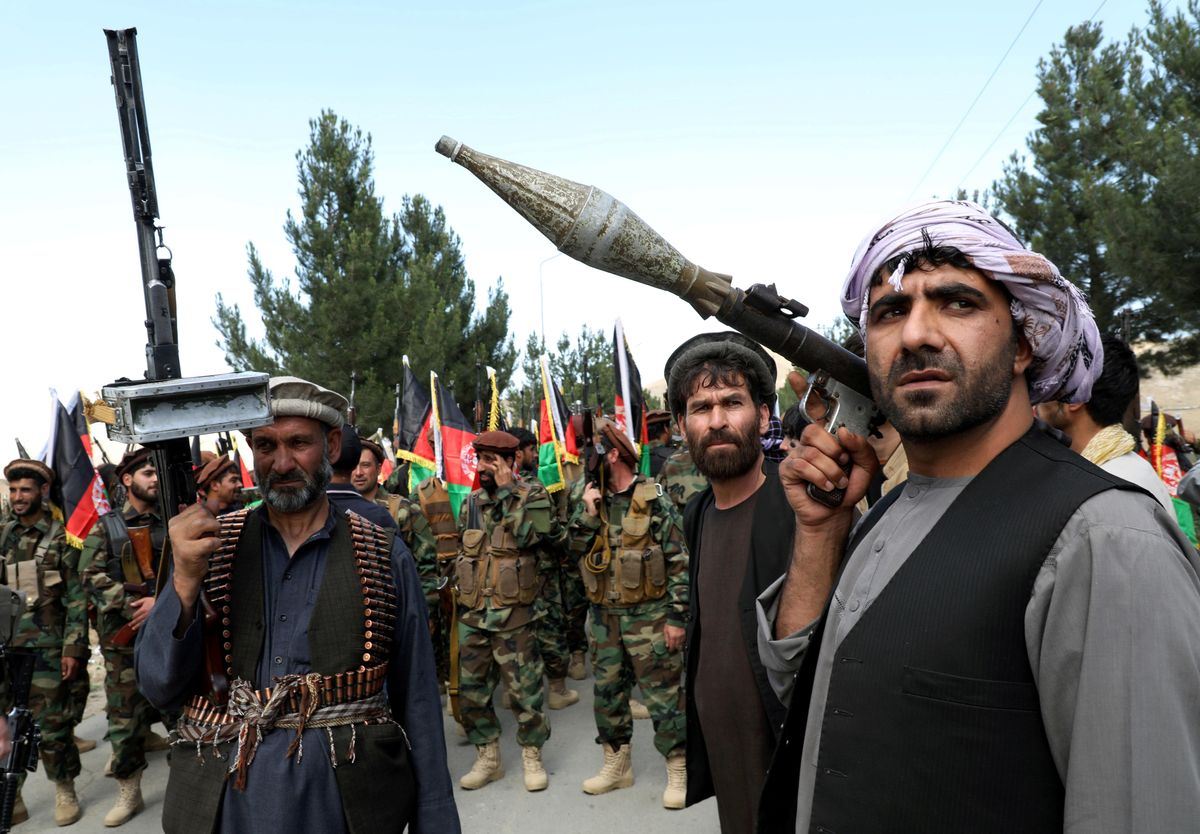 Armed men attend a gathering to announce their support for Afghan security forces and that they are ready to fight against the Taliban, on the outskirts of Kabul, Afghanistan June 23, 2021. 