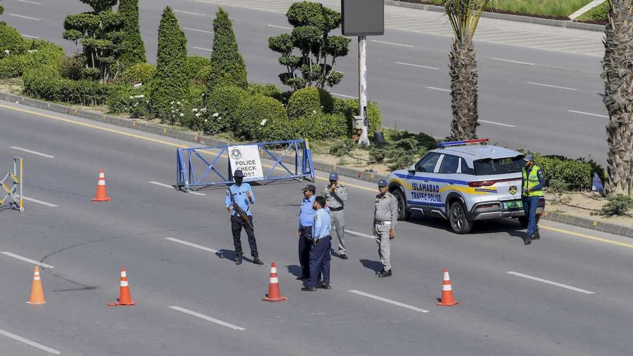 Armed security personnel stand guard near the Serena Hotel in Islamabad, Pakistan, on April 19, 2026.