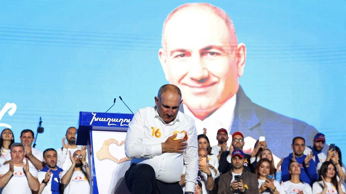 Armenian Prime Minister Nikol Pashinya bowing down with a hand on his heart at a campaign rally