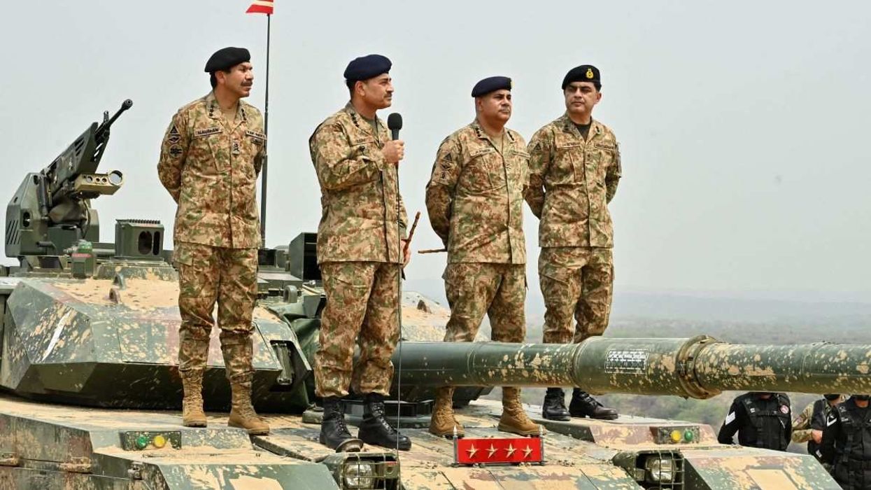 Army Chief Asim Munir holds a microphone at the Tilla Field Firing Ranges in Mangla, Pakistan, on May 1, 2025.